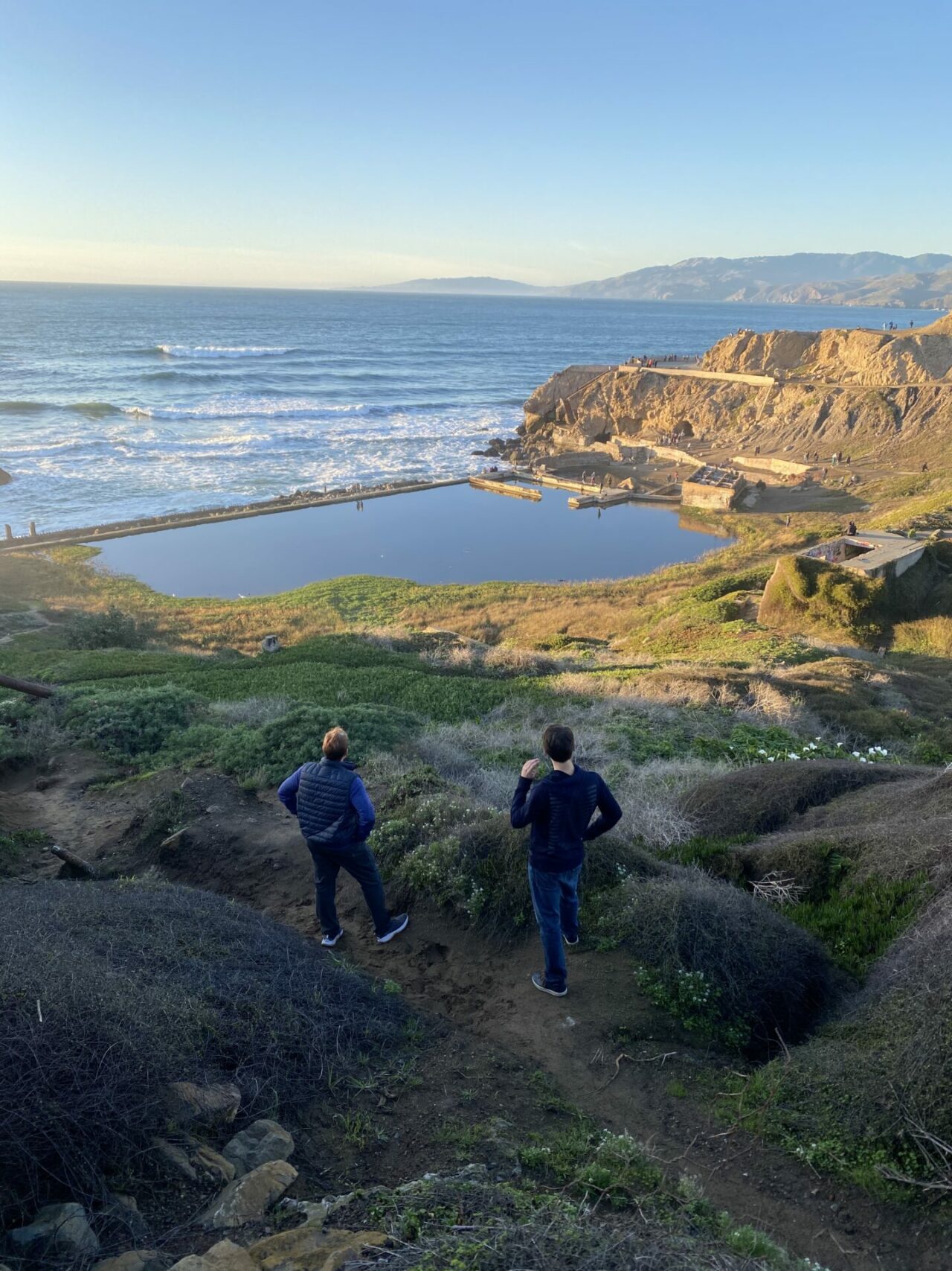 2 men looking over the sutro baths at Land's End hike, San Francisco