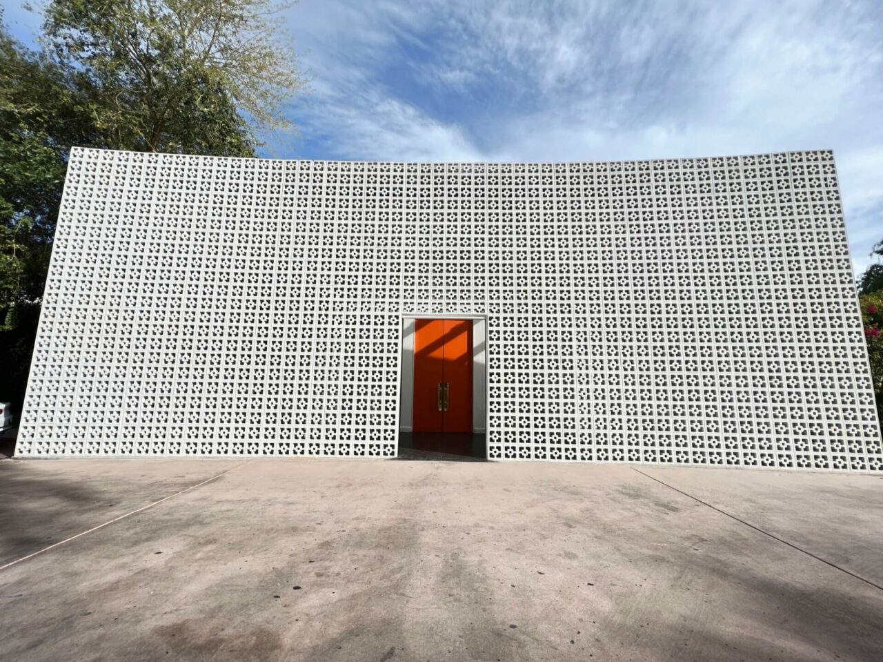 The entrance to The Parker Palm Springs - orange door with concrete 60's brick