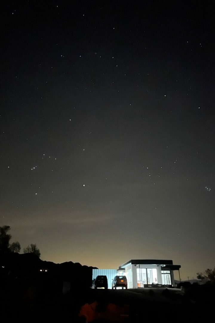 Homestead modern house in Joshua Tree light up in the night sky with stars