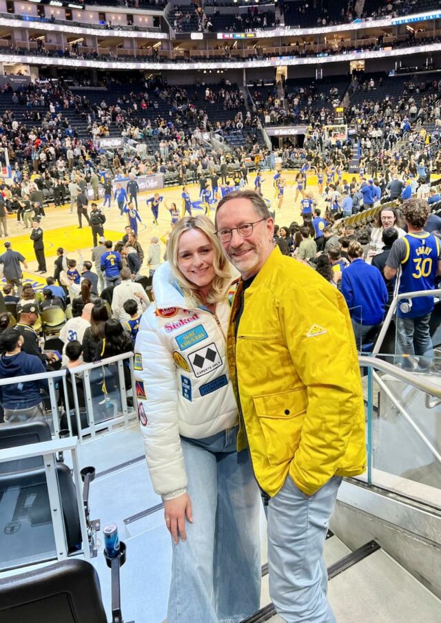 : Dany and Eric posing together at the Chase Center during a Warriors basketball game