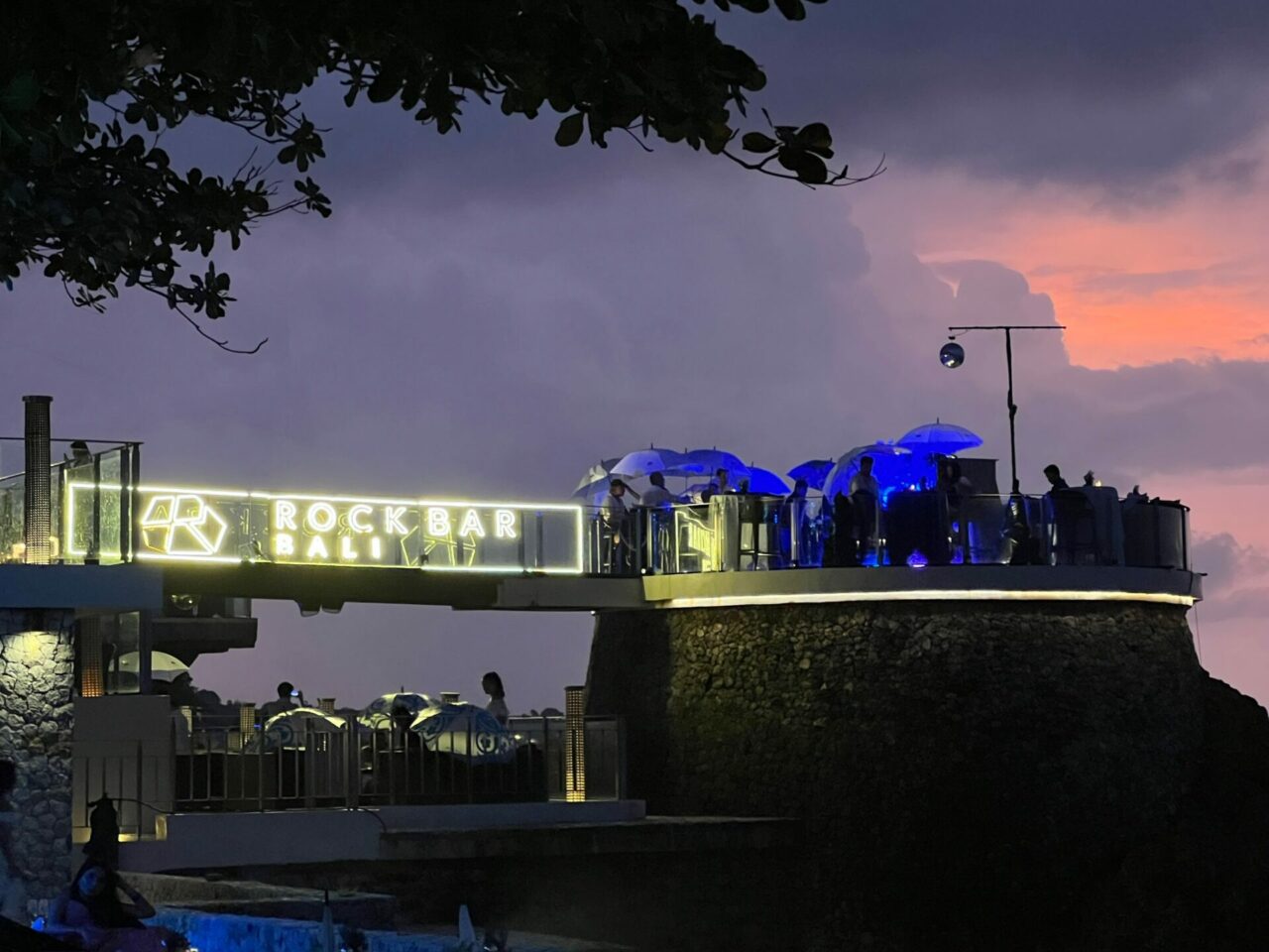 rain and sky changing colour at the rock bar ayana resort bali